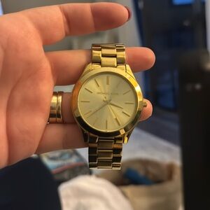 Gold women’s Michael Kors watch